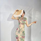 A cyan floral qipao gown for summer.
