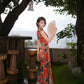 Modern qipao gown with red floral patterns