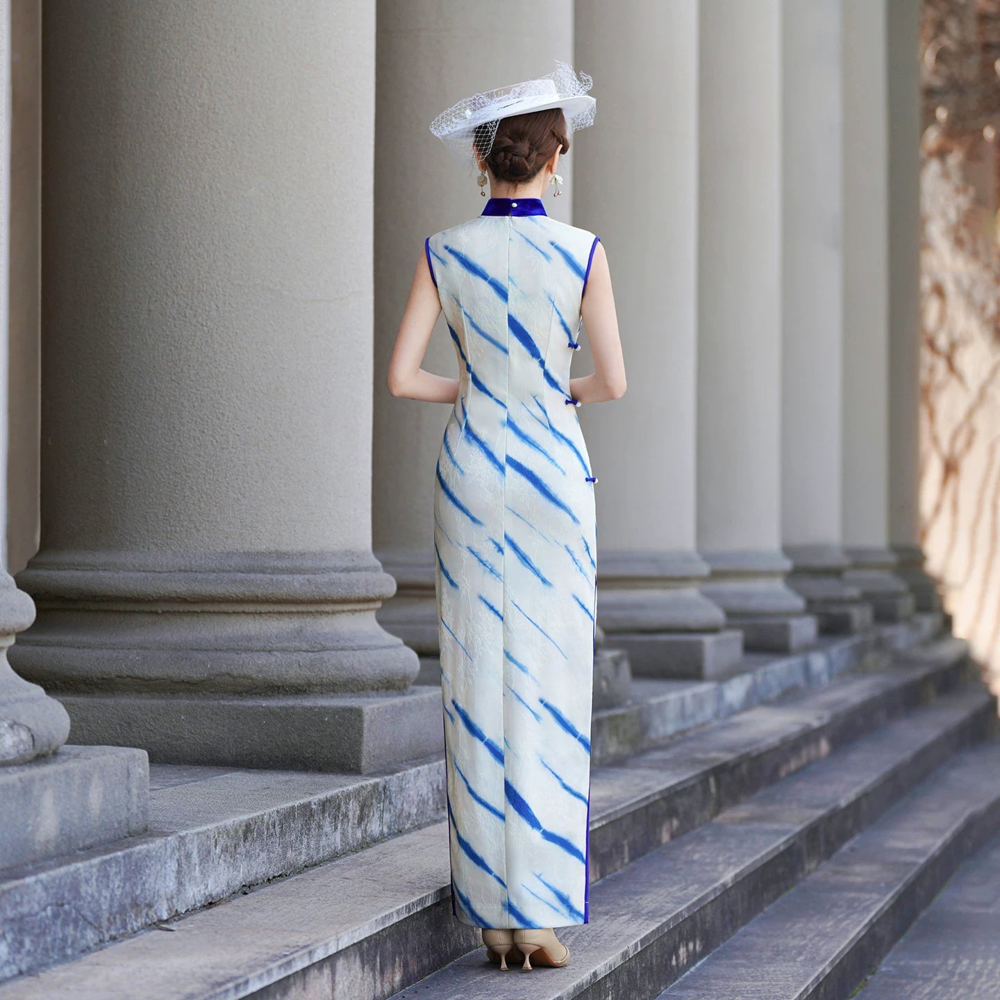 White sleeveless modern qipao gown