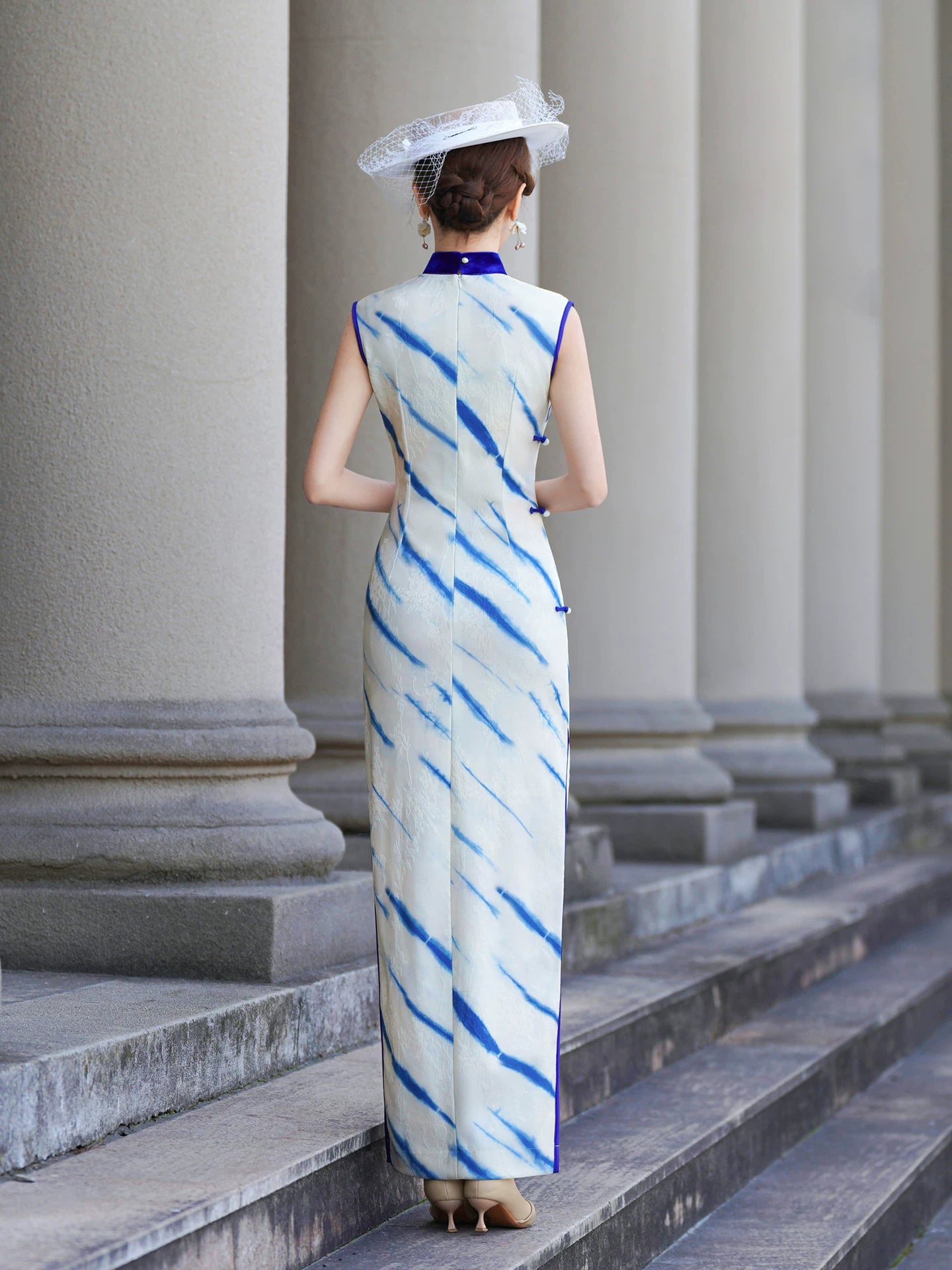 White sleeveless modern qipao gown