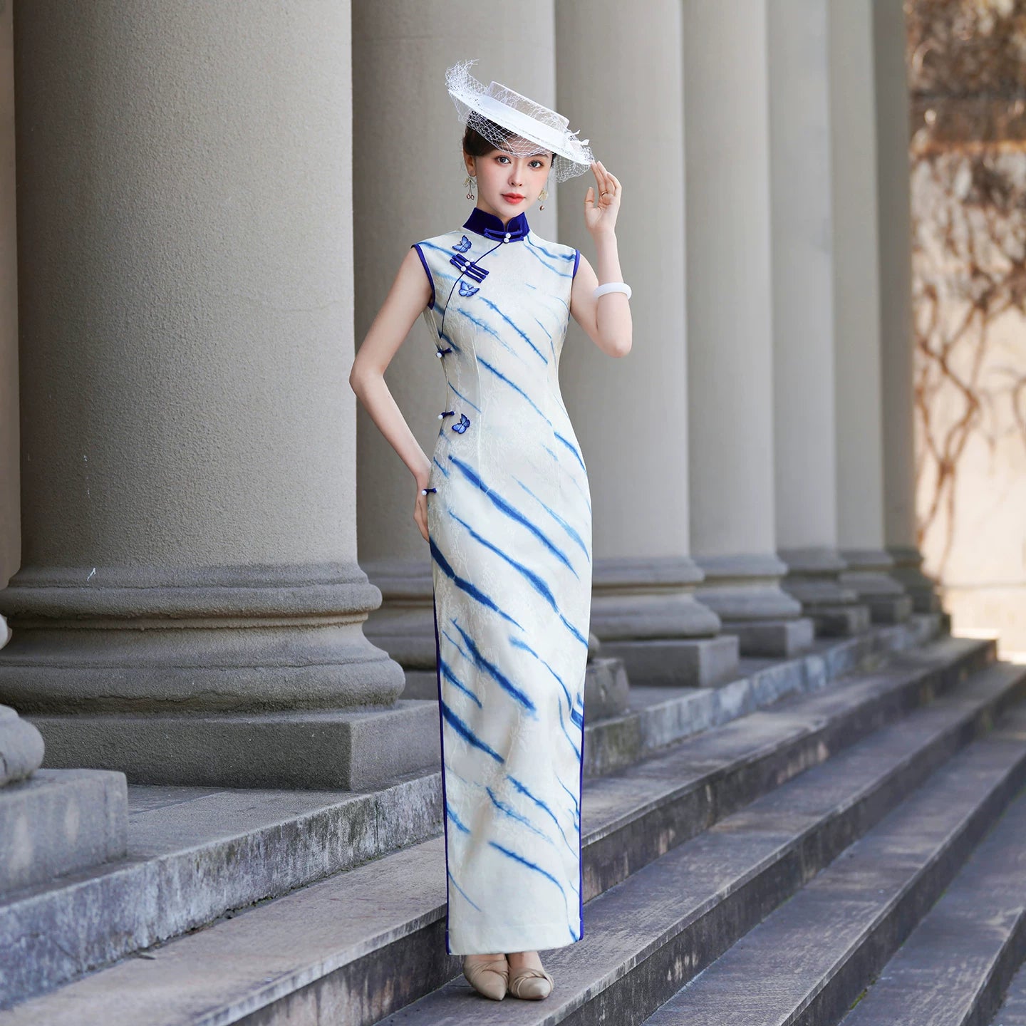 White sleeveless modern qipao gown