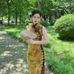 Yellow sleeveless modern qipao with a bamboo print.