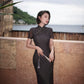 Modern qipao gown with a black plaid print.