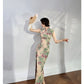 A cyan floral qipao gown for summer.