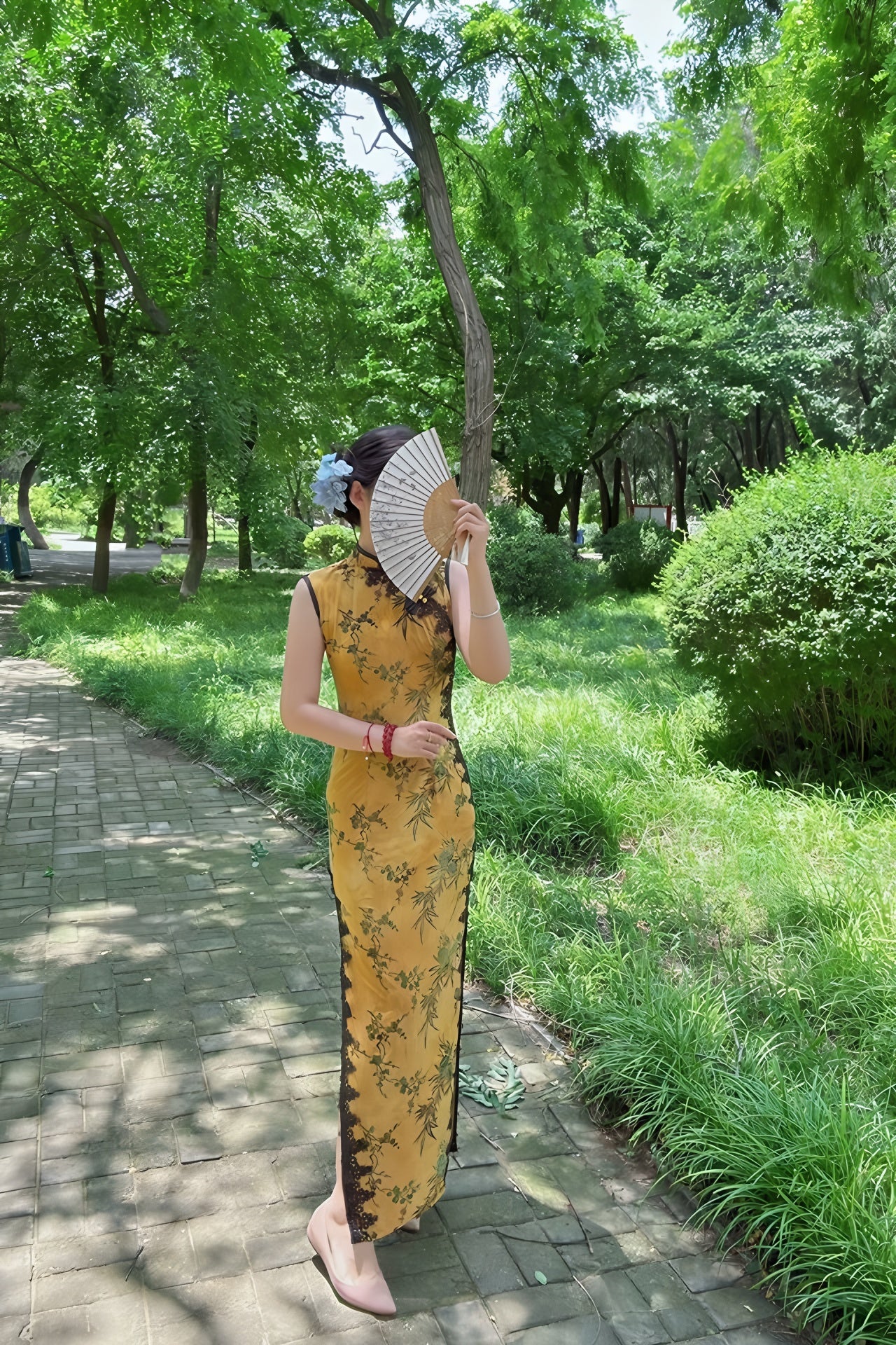 Yellow sleeveless modern qipao with a bamboo print.